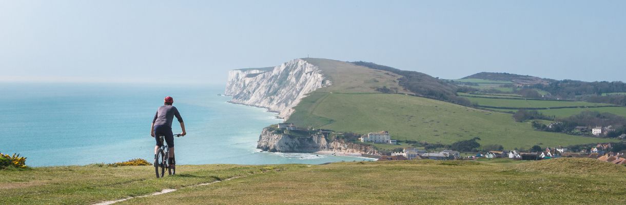 Cyclist at Freshwater with Tennyson Down in background